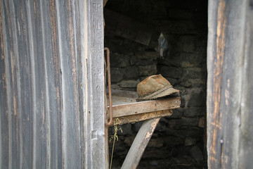 Old leather hat on dusty work bench in shed