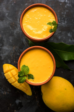 Mango Lassi, Indian popular summer drink in a terracotta glass, selective focus