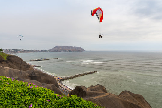 Paraglider flying above the Pacific coast in Miraflores District, in Lima, Peru