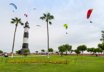View of La Marina Lighthouse (Faro de La Marina) in Miraflores district, with some paragliders in...
