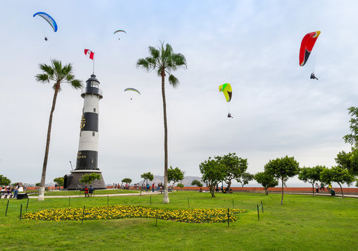 View of La Marina Lighthouse (Faro de La Marina) in Miraflores district, with some paragliders in the sky, in Lima Peru