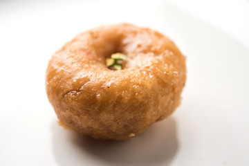 Balushahi sweet food served in a white or golden plate over moody background