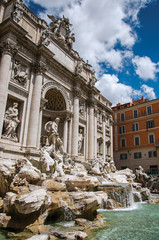 Fototapeta na wymiar Overview of the world-famous Trevi Fountain in sunny day at the city center of Rome, the incredible city of the Ancient Era, known as 