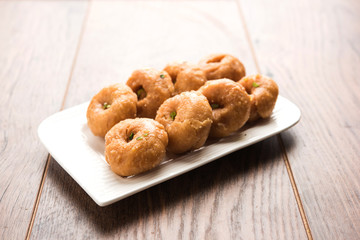 Balushahi sweet food served in a white or golden plate over moody background