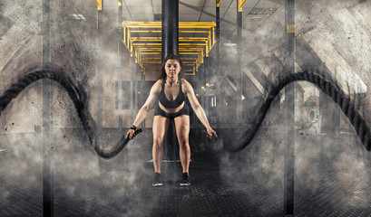 Woman working out with battle ropes