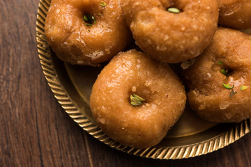 Balushahi sweet food served in a white or golden plate over moody background