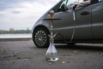 Hookah on the background of cars and rivers