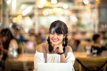 Asian young girl on tablet in internet cafe,select focus.