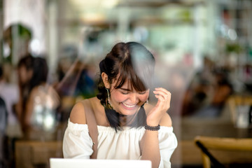 Asian young girl on tablet in internet cafe,select focus.