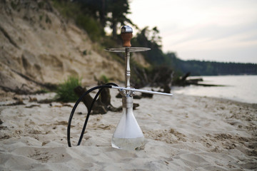 Hookah shisha smoke on beach background