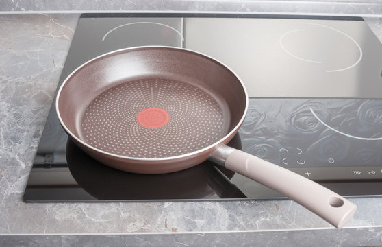 Frying pan on modern electric stove close up