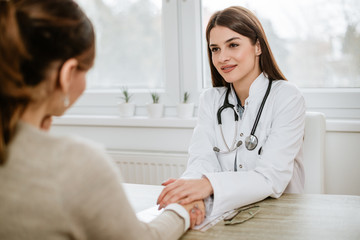 Healthcare and medicine concept. Medical doctor in white uniform gown coat counseling female...