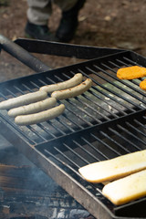 bread and sausages on a grill