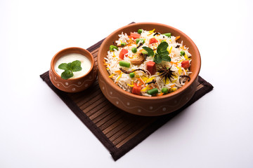 Indian Cuisine Kadhi - Vegetarian Curry Made of Buttermilk And Chick Pea Flour. served in a bowl or Karahi over moody background, selective focus
