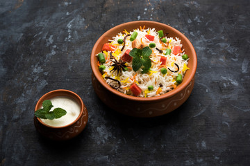 Indian Vegetable Pulav or Biryani made using Basmati Rice, served in a ceramic bowl. selective focus