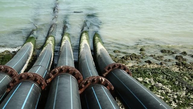 Pipes for intake of sea water and desalination in Doha, Qatar. Desalinization of sea water for city needs, water intake from Persian Gulf, Arabian Peninsula