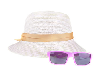 A summer hat from the sun with a yellow ribbon and pink glasses. Isolated