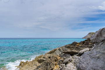 Fototapeta na wymiar Mallorca, Rough rocky cliff line of island coast with blue sea water nature landscape
