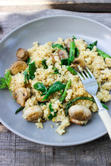 Warm bulgur salad with fried mushrooms, asparagus and spinach