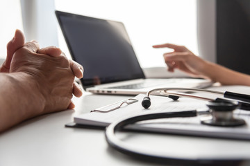 Female Doctor discussing with senior man patient.