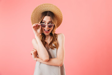 Mystery happy brunette woman wearing in dress, hat and sunglasses