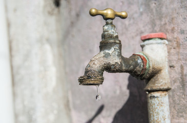 Antique tap with water drop