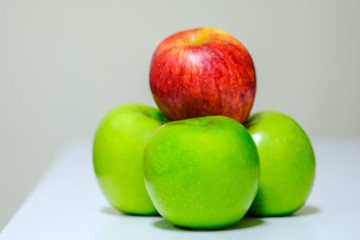 Close up of fresh red and green apple on table.