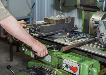  machinist working a metal lathe