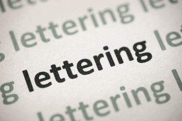 Obraz premium word lettering printed on paper macro