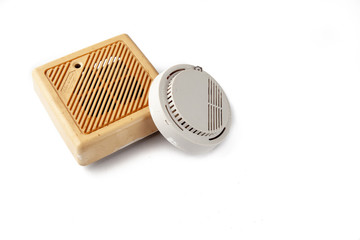 Old domestic smoke detector alarms on white background