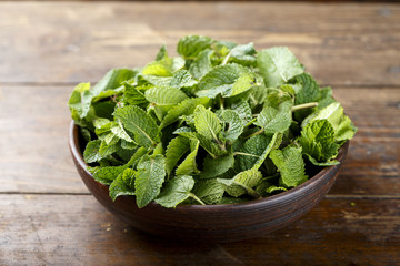 Green fresh mint om the wooden table