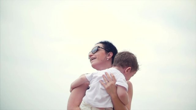 Young family, mother and children are walking along the coast. Happy family walking on sea coast.