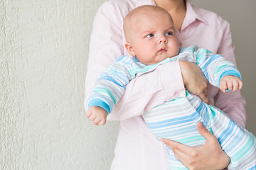 Mother holding adorable baby son