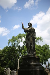 Fototapeta na wymiar Woman Statue Monument in a Cemetery