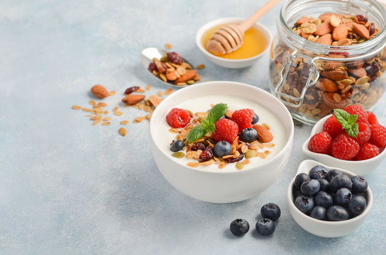 Homemade granola with yogurt and fresh berries, healthy breakfast concept, selective focus, copy space.