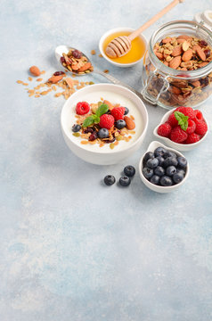 Homemade granola with yogurt and fresh berries, healthy breakfast concept, selective focus, copy space.