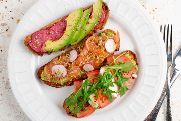 Assortment of healthy breakfast toasts on a dish