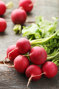 Red radishes on grey wooden table