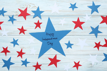 Paper star with inscription Happy Independence Day on wooden table