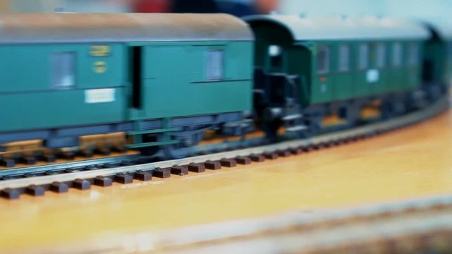 Retro toy train with wagons moving.