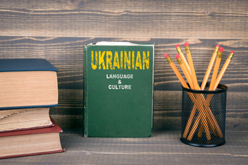 Ukrainian language and culture concept. Book on a wooden background