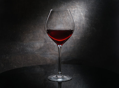 Red wine glass on gray background