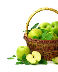 Basket of apples on a white background. Juicy green apples with leaves. Healthy eating. Gardening.