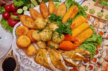 Boiled potatoes with herbs, pancakes with meat, crab sticks in batter