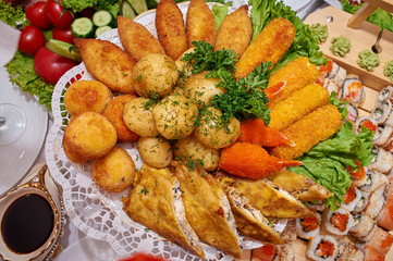 Boiled potatoes with herbs, pancakes with meat, crab sticks in batter