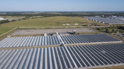 Aerial agricultural view of lettuce production field and greenhouse