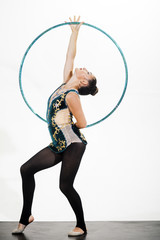 Woman train acrobatics with hula hoop in sportswear. Fitness and dieting of girl gymnast. Woman with gymnastic ring. Workout sports activities in gym of flexible girl. Sport success and health