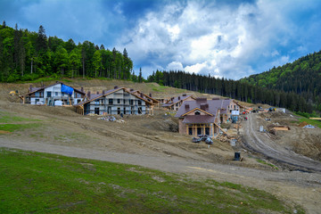 Fototapeta premium Construction of cottages in the mountains, Carpathians, Ukraine.