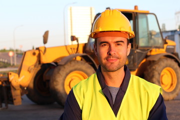 Construction driver with excavator on the background