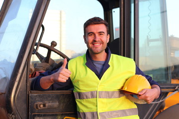 Construction driver with excavator on the background © ajr_images